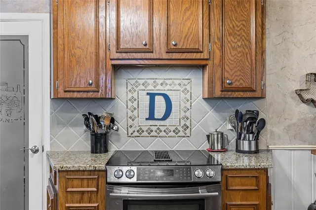 a kitchen with stainless steel appliances granite countertop a stove and a cabinets