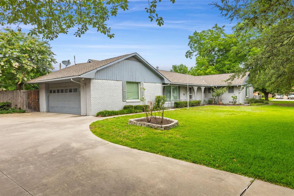 1302 Culver Street Commerce, TX 75428 - Photo 2 of 40 a front view of a house with a yard