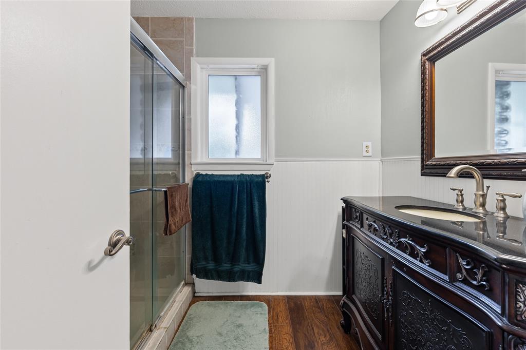 1302 Culver Street Commerce, TX 75428 - Photo 23 of 40 a view of a bathroom with a sink and a window