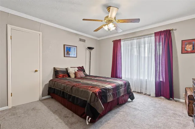a bedroom with a bed and a ceiling fan