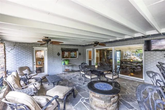 a view of a livingroom with furniture and floor to ceiling window