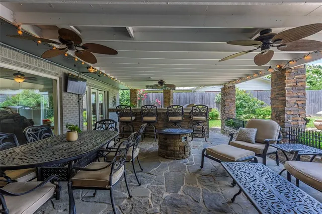 a outdoor space with lots of tables a large window and furniture