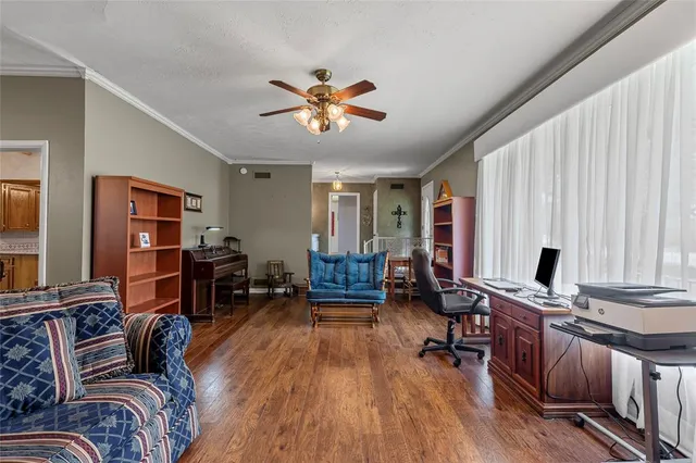 a living room with furniture and wooden floor