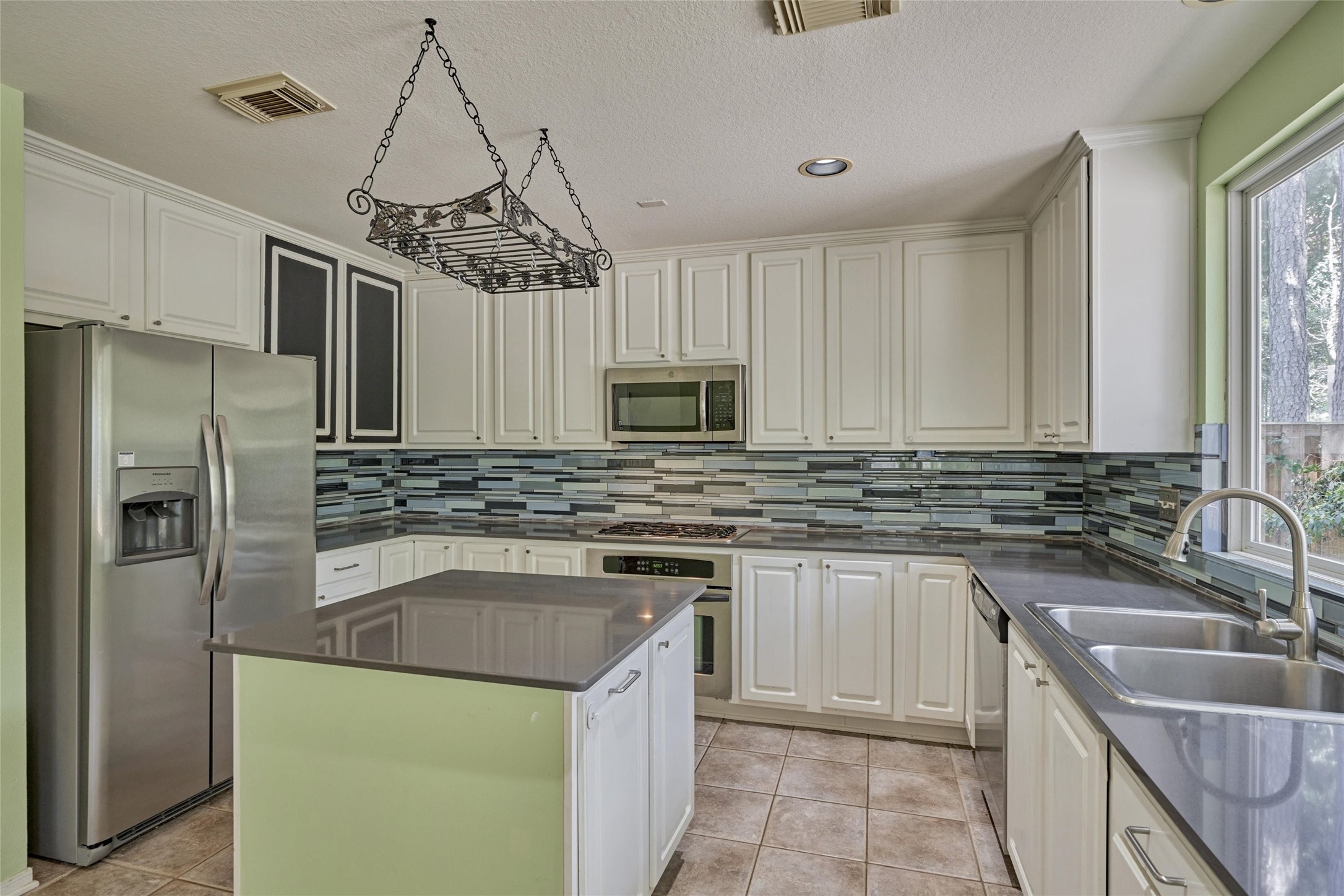 59 West Gaslight Place Spring, TX 77382 - Photo 20 of 47 Refrigerator included. Chalkboard cabinets for grocery list, family notes.