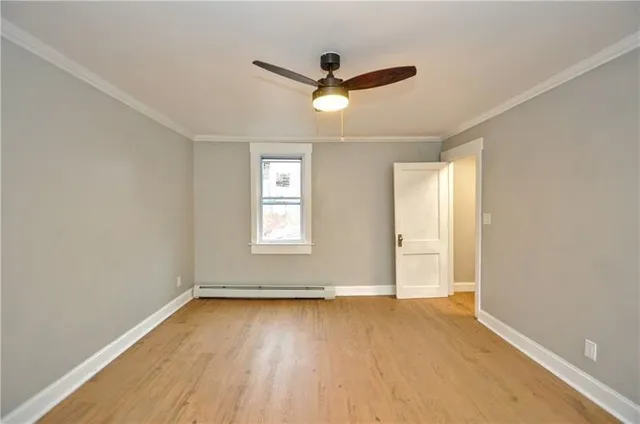 wooden floor in an empty room with a window