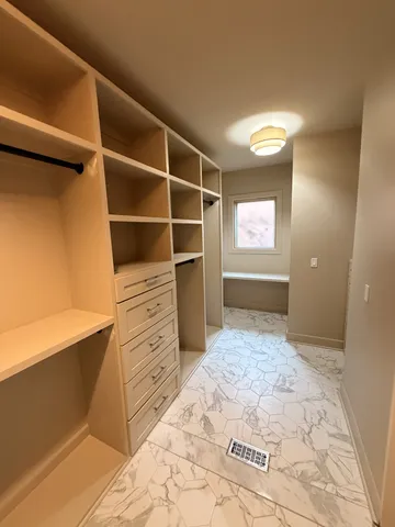 a view of an empty room with a fireplace and a window