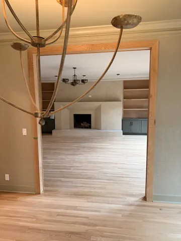 a large kitchen with stainless steel appliances kitchen island a large counter top and a view of living room