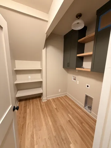 a view of an empty room with window and stairs