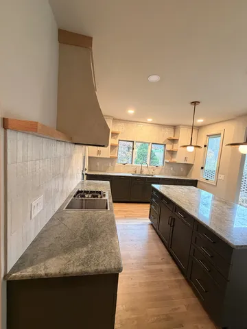 a bathroom with a double vanity sink toilet mirror and bathtub
