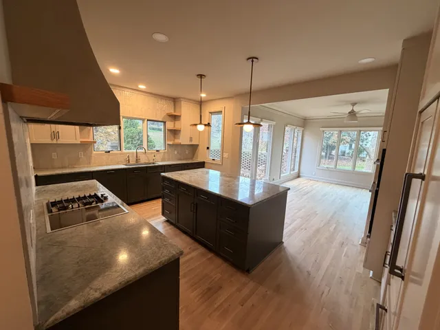 a bathroom with a sink mirror and shower