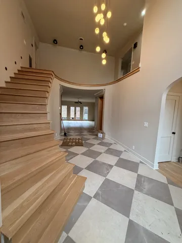 a view of empty room with wooden floor and window