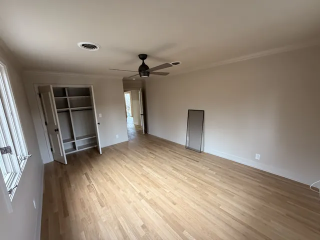a kitchen with stainless steel appliances granite countertop a sink a island a stove and a wooden floor