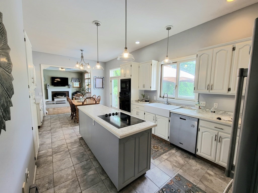43 Mendon Road Sutton, MA 01590 - Photo 11 of 37 a kitchen with stainless steel appliances granite countertop a sink a stove and a refrigerator