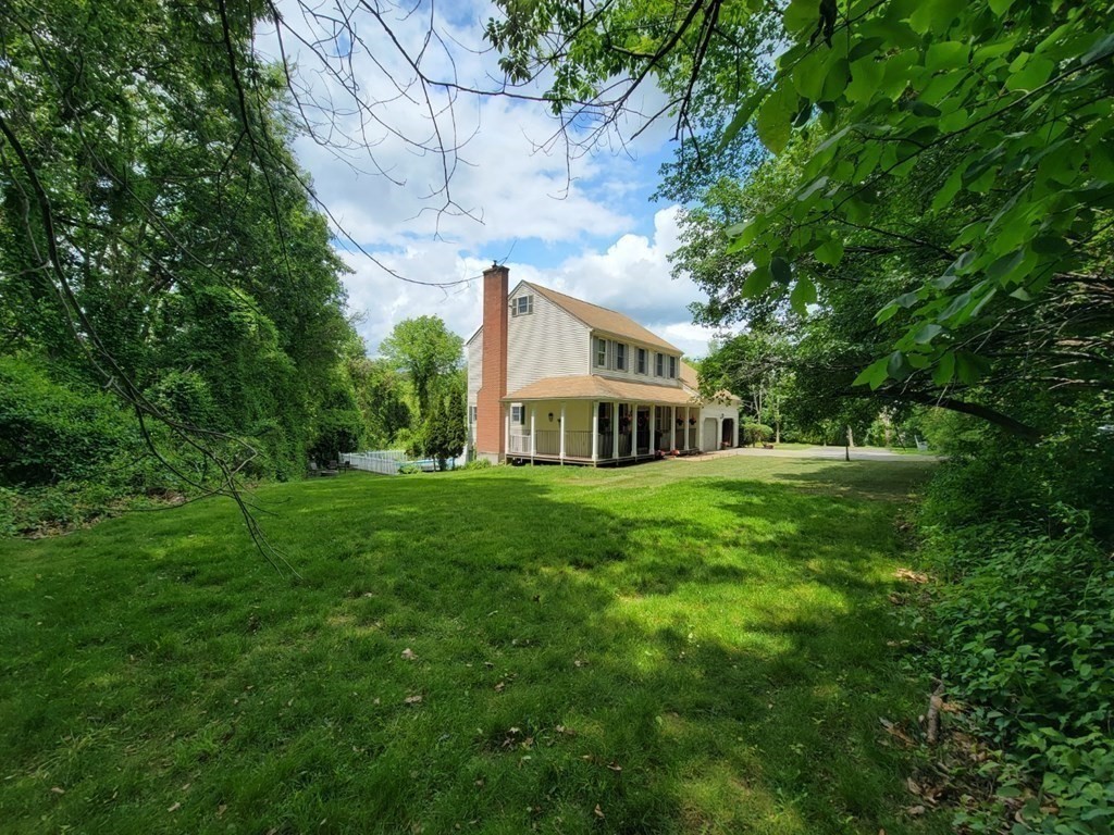 43 Mendon Road Sutton, MA 01590 - Photo 2 of 37 a view of a house with a big yard plants and large trees