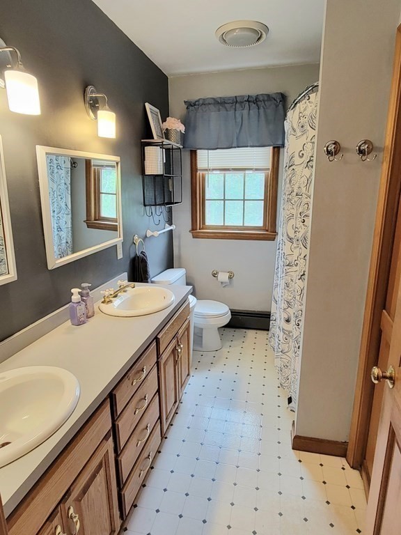 43 Mendon Road Sutton, MA 01590 - Photo 24 of 37 a bathroom with a sink a toilet and shower