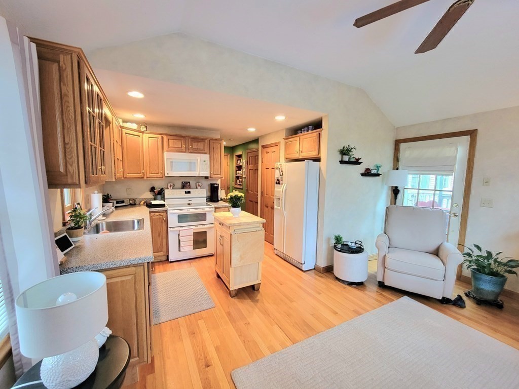 43 Mendon Road Sutton, MA 01590 - Photo 30 of 37 a kitchen with stainless steel appliances kitchen island granite countertop a refrigerator a stove and a sink with granite countertops