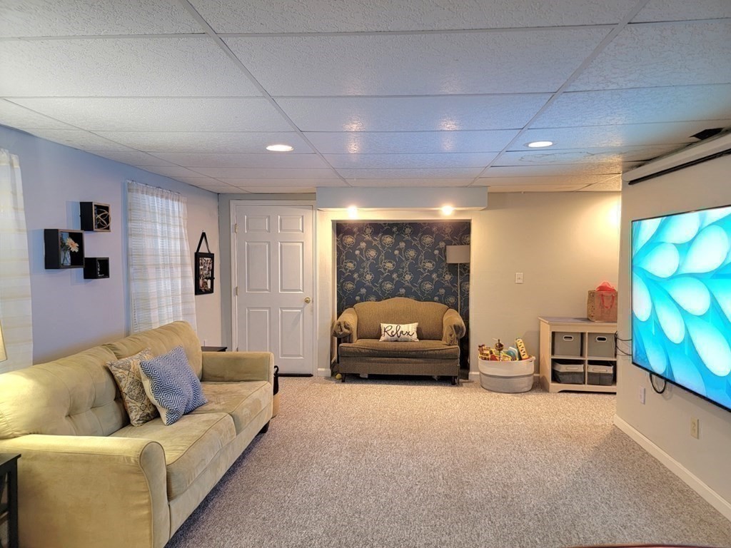43 Mendon Road Sutton, MA 01590 - Photo 32 of 37 a living room with furniture and a flat screen tv