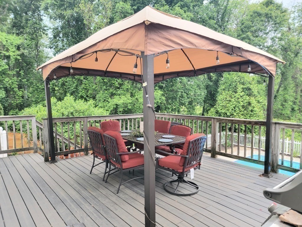 43 Mendon Road Sutton, MA 01590 - Photo 34 of 37 a patio with wooden floor a yard a yard table and chairs