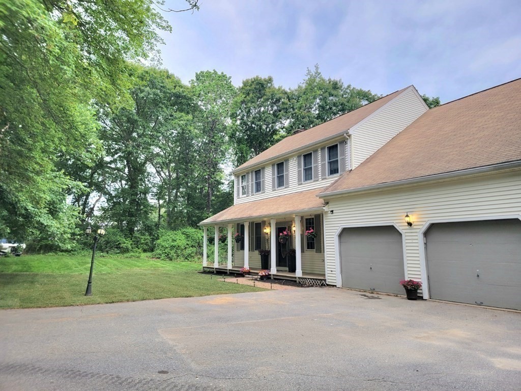 43 Mendon Road Sutton, MA 01590 - Photo 36 of 37 a front view of a house with a yard and garage