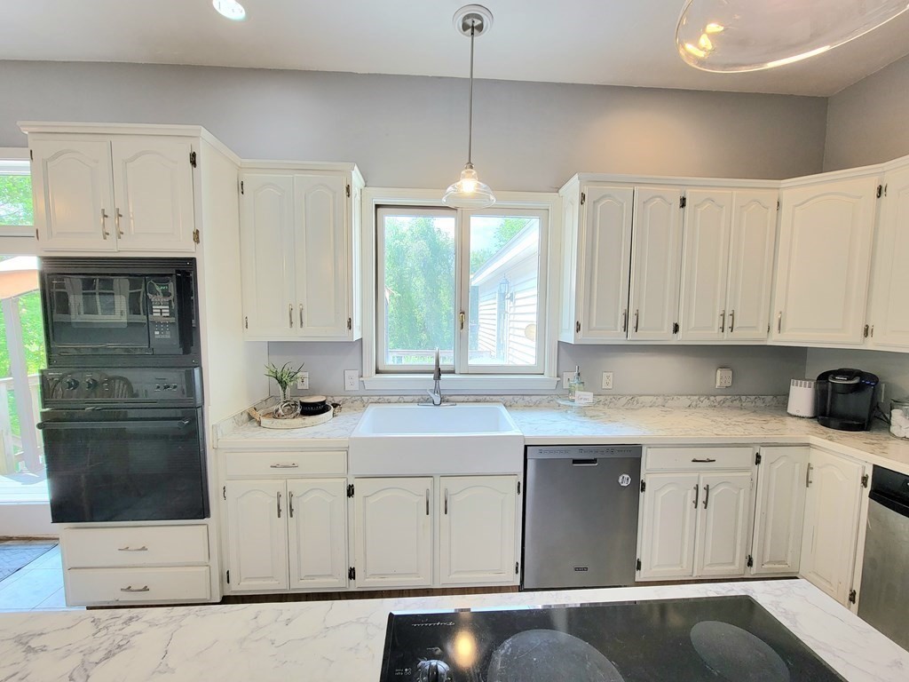 43 Mendon Road Sutton, MA 01590 - Photo 8 of 37 a kitchen with a sink window and cabinets