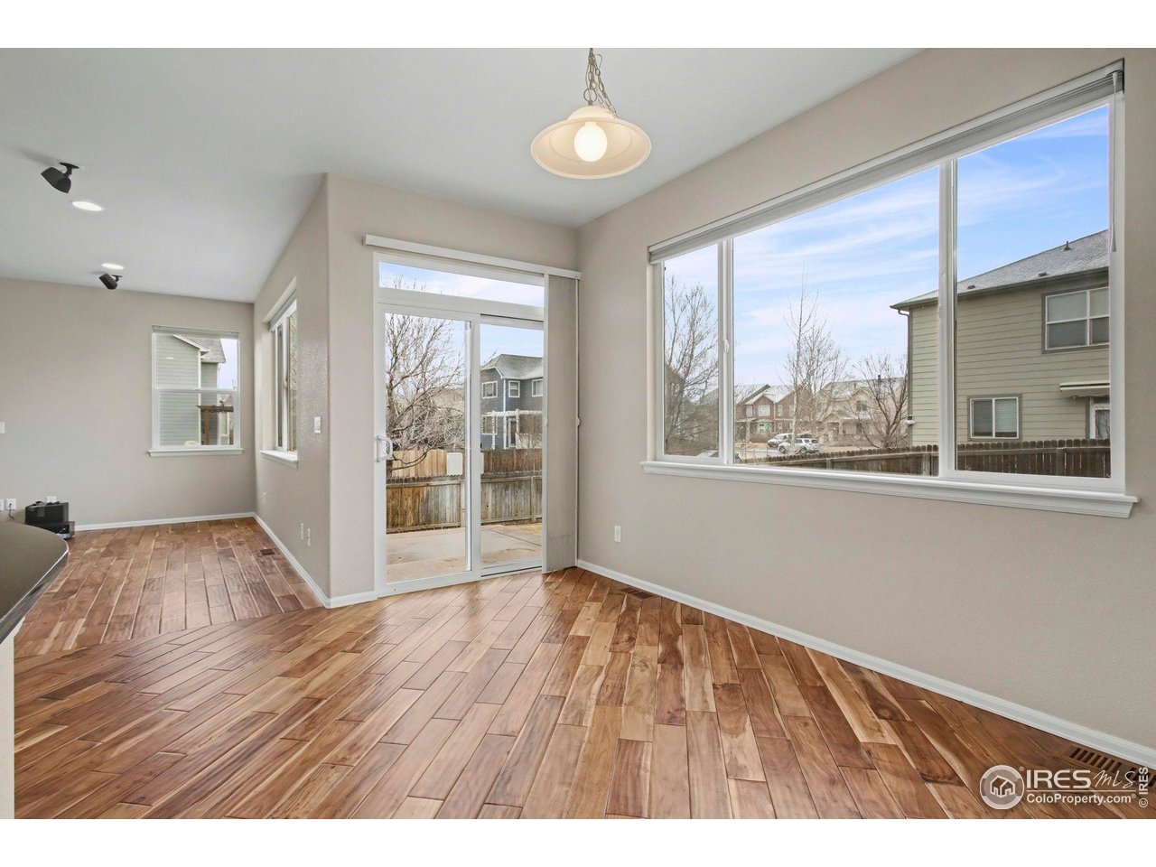 5894 Graphite Street Timnath, CO 80547 - Photo 16 of 50 a view of an empty room with wooden floor and a window