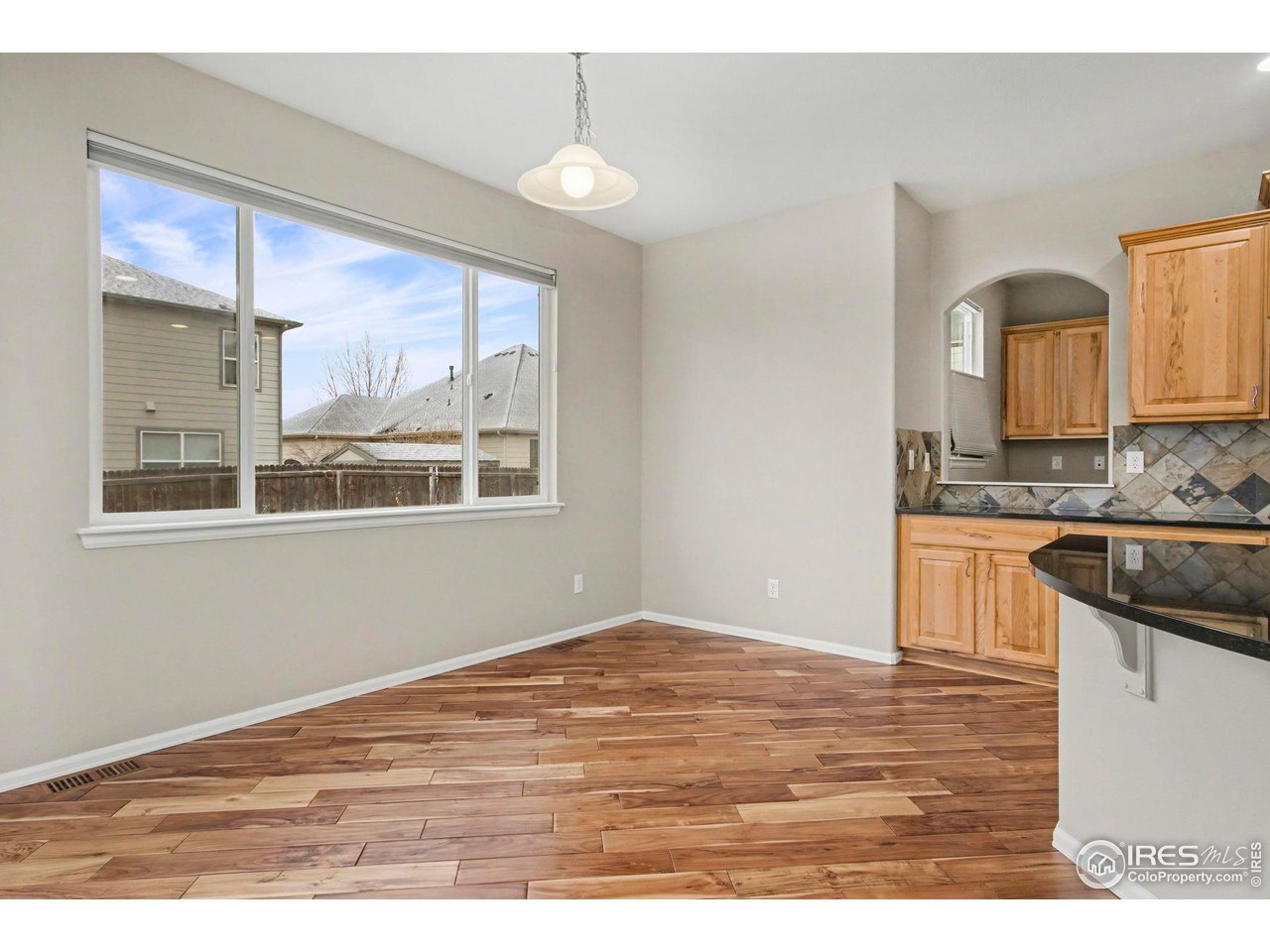 5894 Graphite Street Timnath, CO 80547 - Photo 18 of 50 a view of a kitchen cabinets and wooden floor