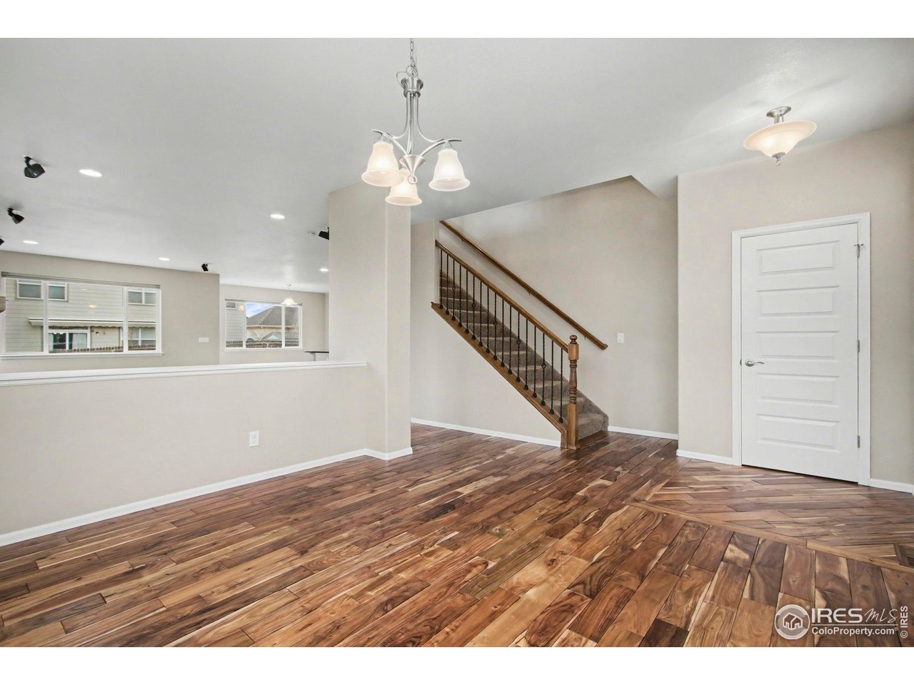 5894 Graphite Street Timnath, CO 80547 - Photo 23 of 50 a view of an empty room with wooden floor and staircase