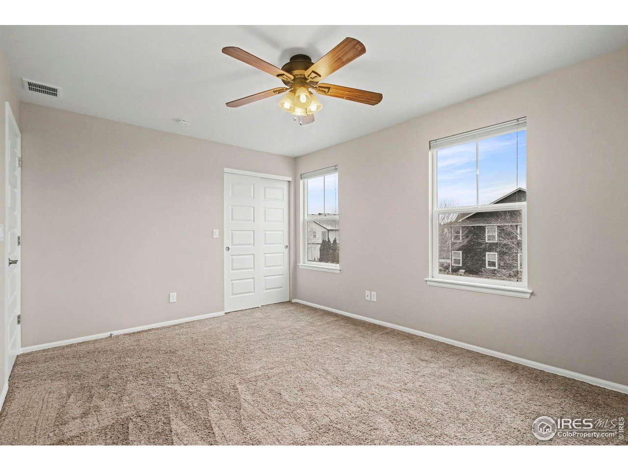 5894 Graphite Street Timnath, CO 80547 - Photo 32 of 50 a view of an empty room with window and a ceiling fan