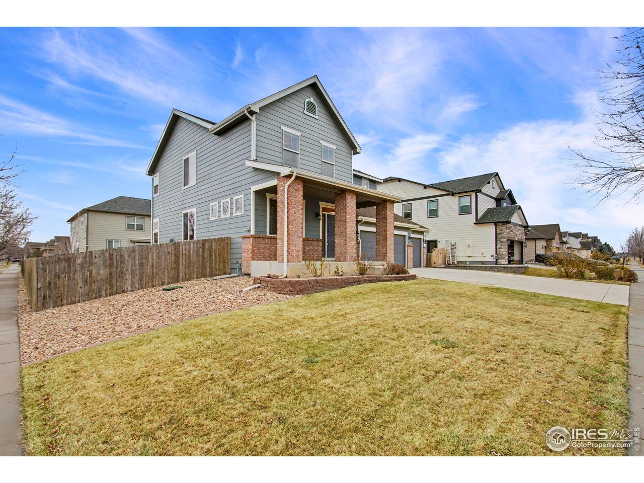 5894 Graphite Street Timnath, CO 80547 - Photo 5 of 50 a swimming pool with yard and wooden fence