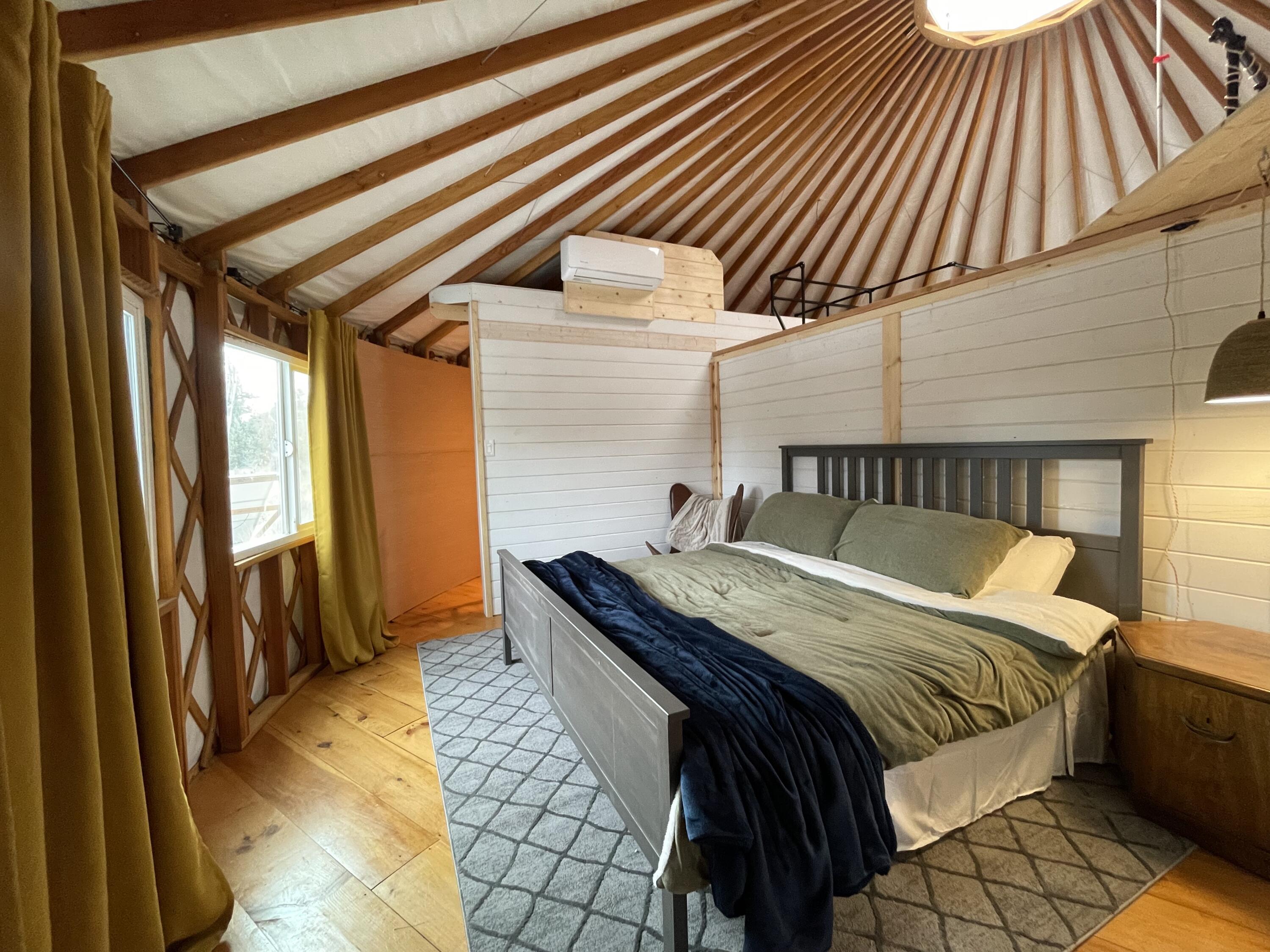 60360 Horse Butte Road Bend, OR 97702 - Photo 35 of 58 a bedroom with a bed and wooden floor
