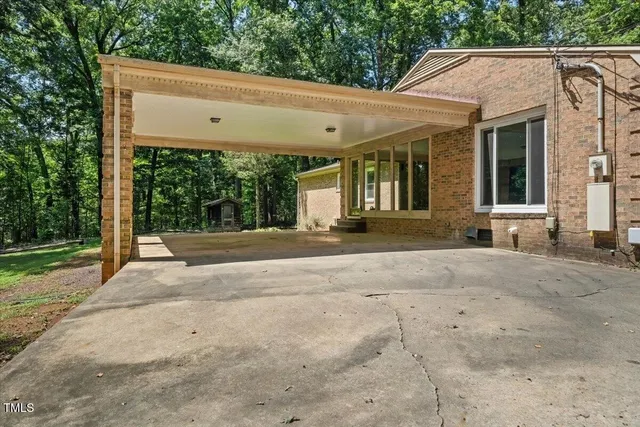 a kitchen with stainless steel appliances granite countertop a stove and a large window