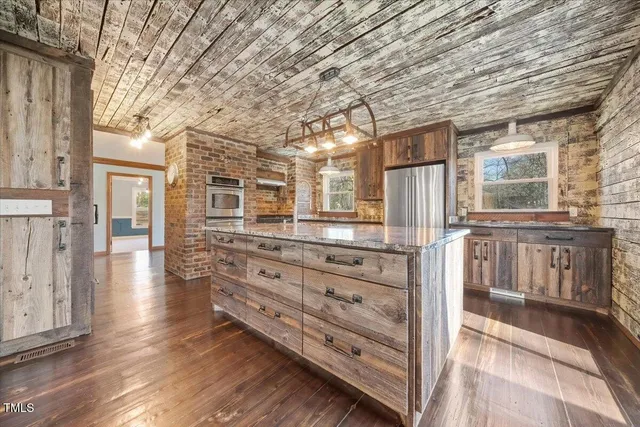 a kitchen with stainless steel appliances granite countertop a stove and a refrigerator