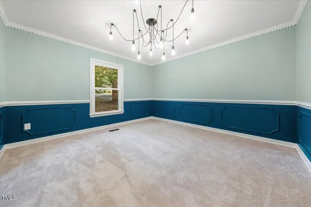 a view of an empty room with a chandelier