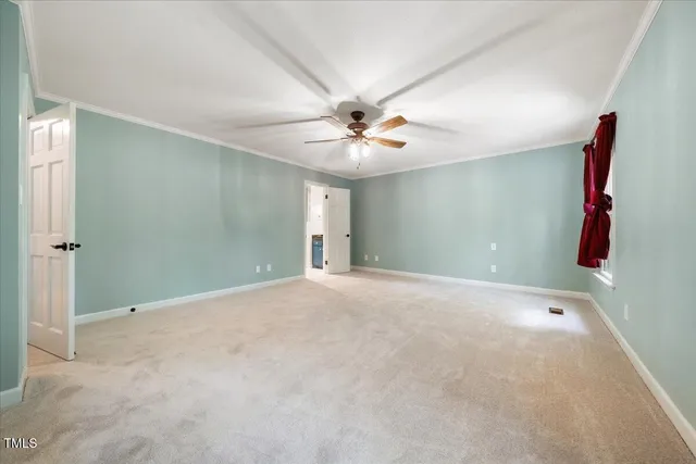 a view of an empty room with a cabinet and a window