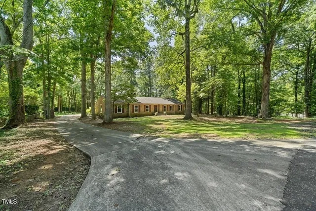 a view of a house with large trees