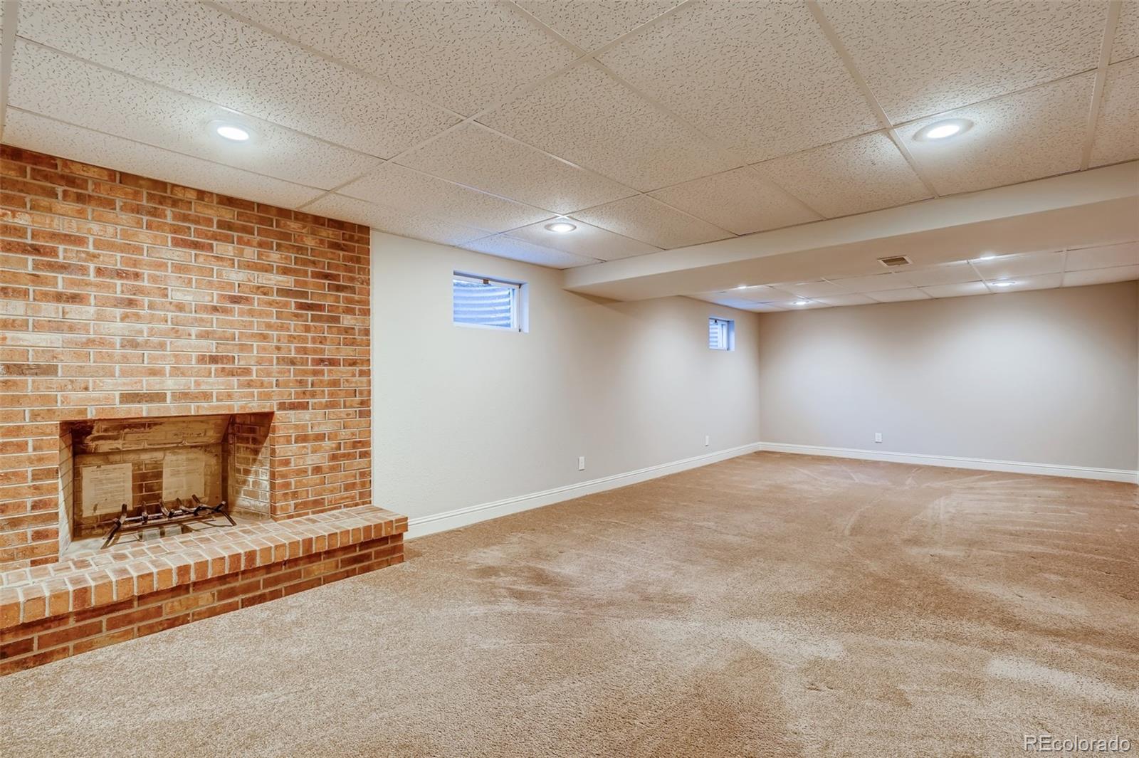 8022 West 78th Way Arvada, CO 80005 - Photo 22 of 30 a view of an empty room with a fireplace