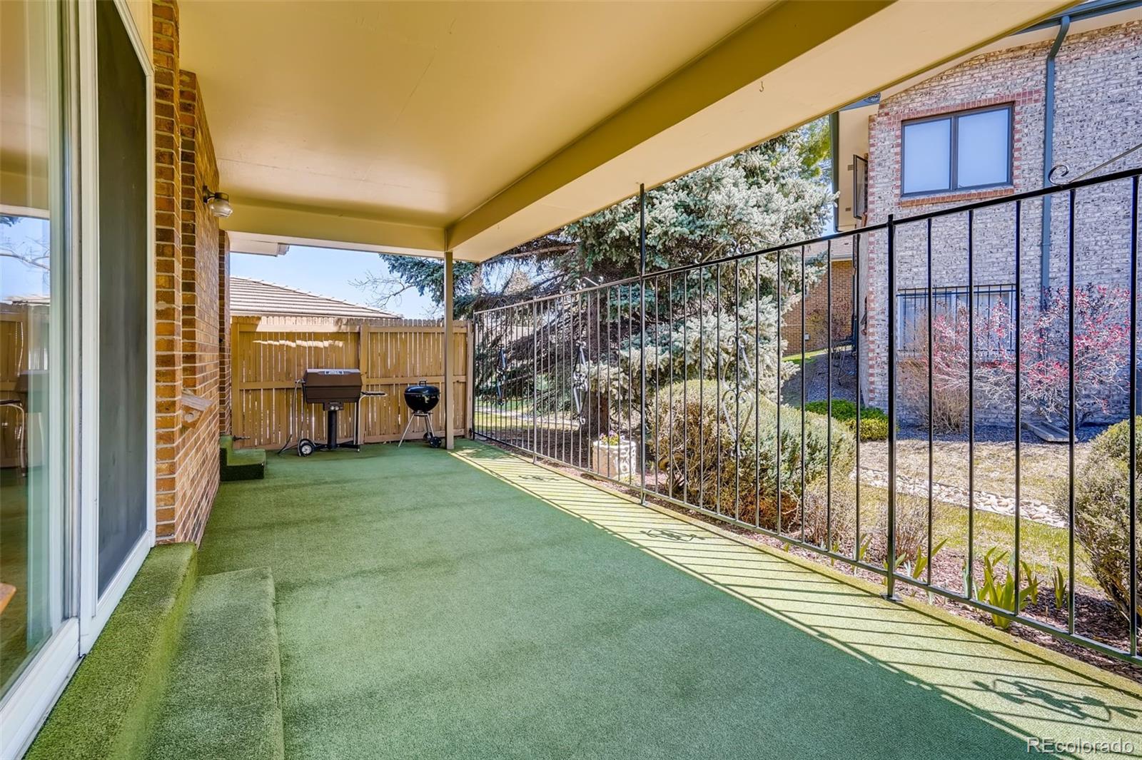 8022 West 78th Way Arvada, CO 80005 - Photo 28 of 30 a view of a porch with a yard