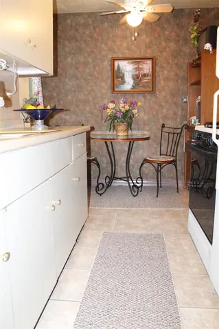 a view of a kitchen with dining area and chandelier