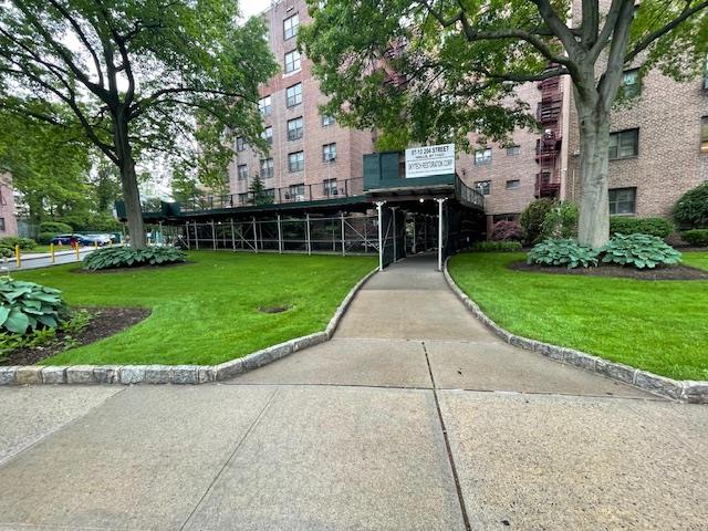 87-10 204th Street, Unit A62 Queens, NY 11423 - Photo 2 of 16 front view of a house with a garden