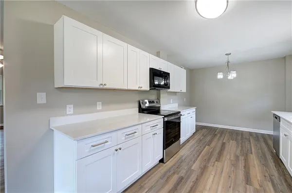 a kitchen with a sink window and stainless steel appliances
