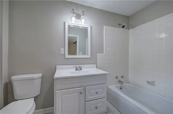 a bathroom with a sink toilet vanity and bathtub