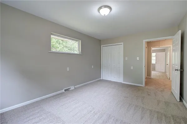 an empty room with a empty space and windows