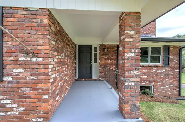 a view of entryway with brick walls