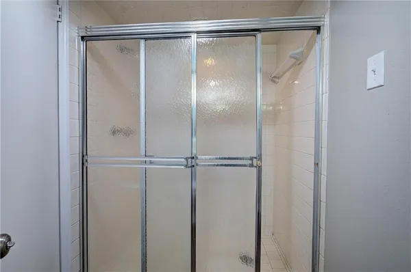 a bathroom with a glass shower door