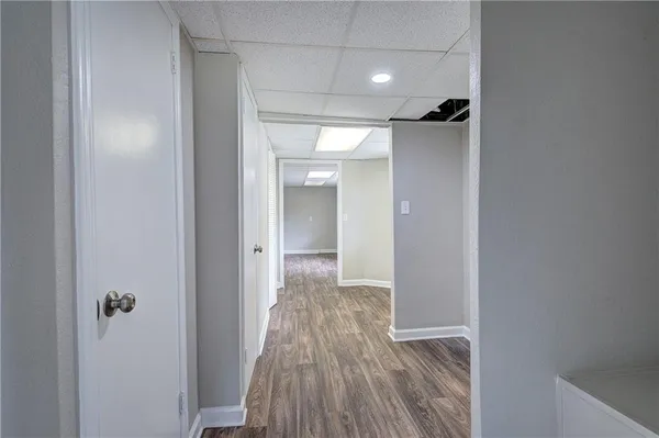 a view of hallway with wooden floor