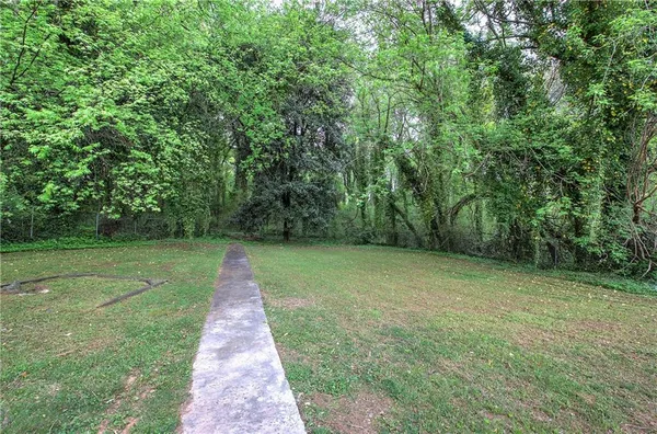 a view of a park with large trees