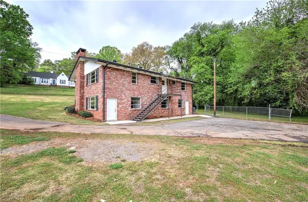 a view of a house with a yard and tree s