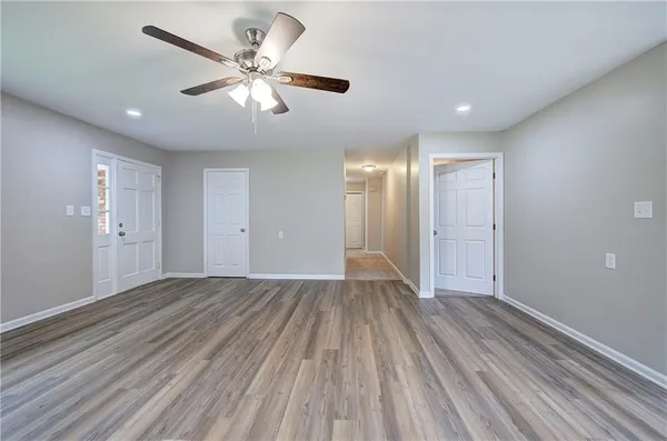 a view of an empty room with wooden floor