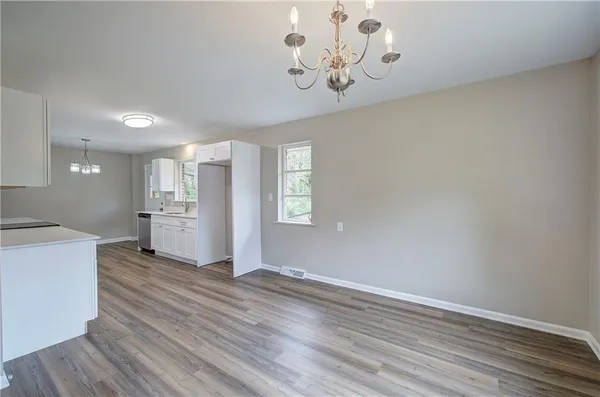 a view of a kitchen with a dishwasher cabinets and wooden floor