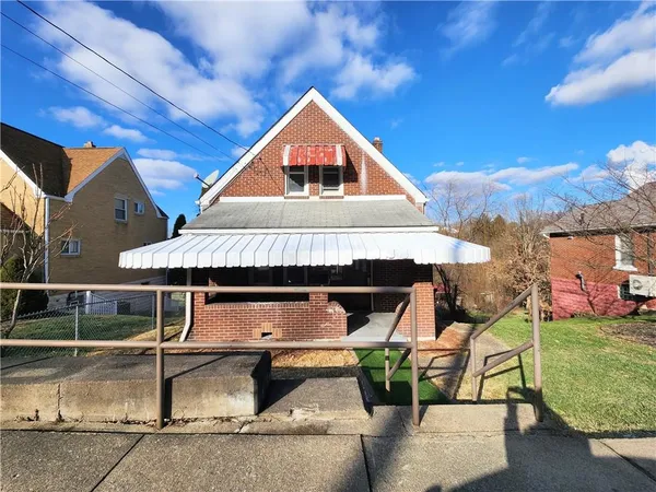 a aerial view of a house with roof deck front of house